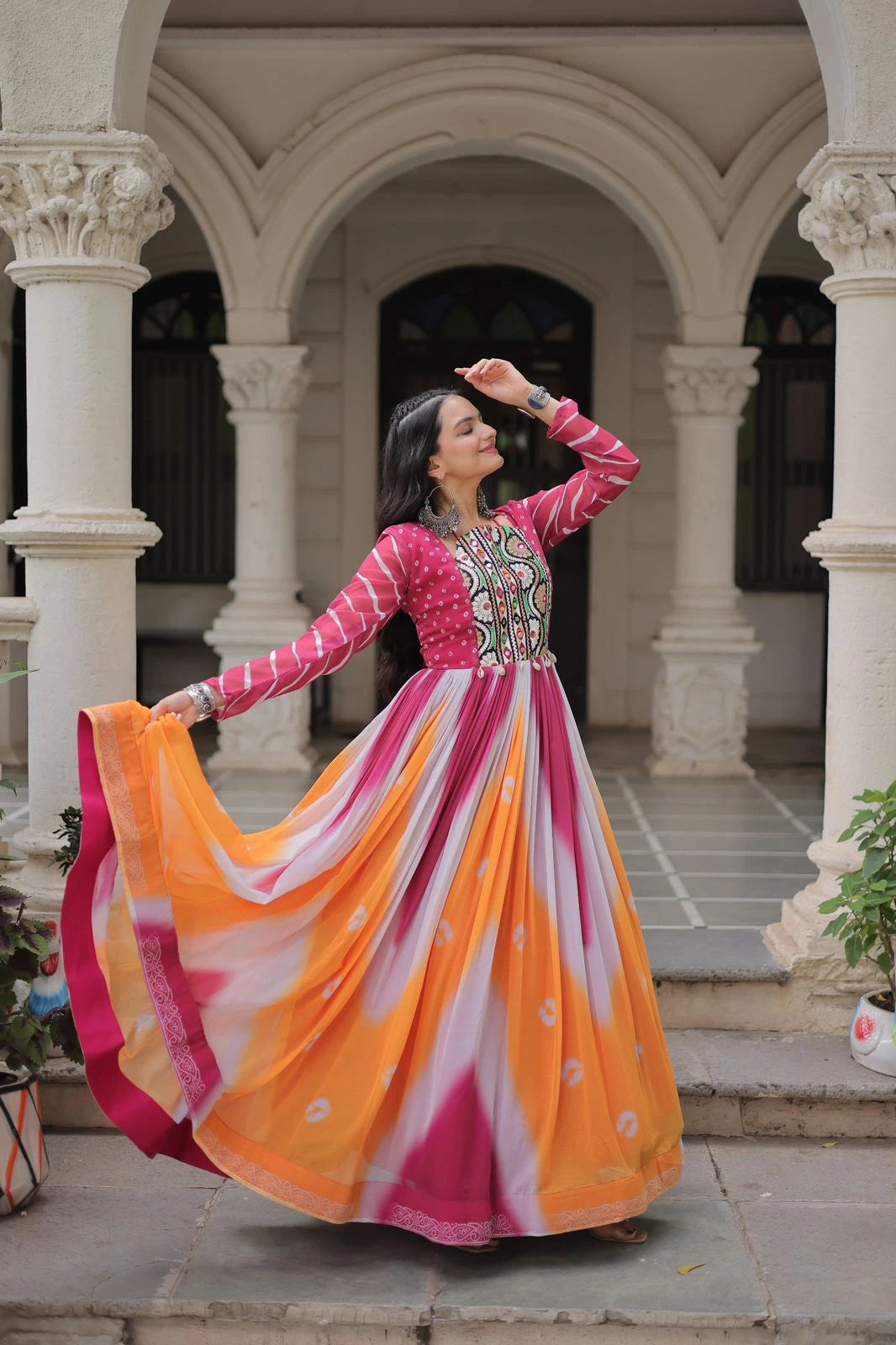 Woman in a colorful traditional outfit standing in an architectural setting