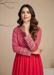 Woman wearing a red patterned dress against a beige background