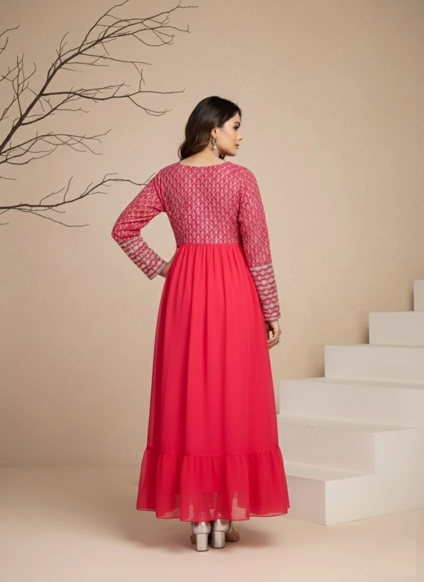 Woman wearing a red dress with white patterns in a minimalistic setting