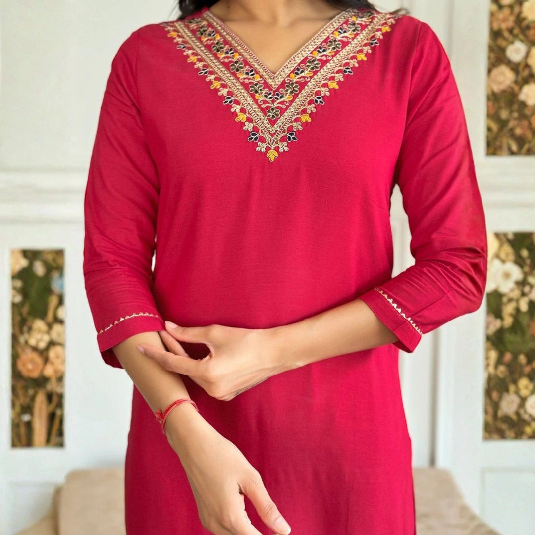 Red kurta with intricate embroidery on a neutral background