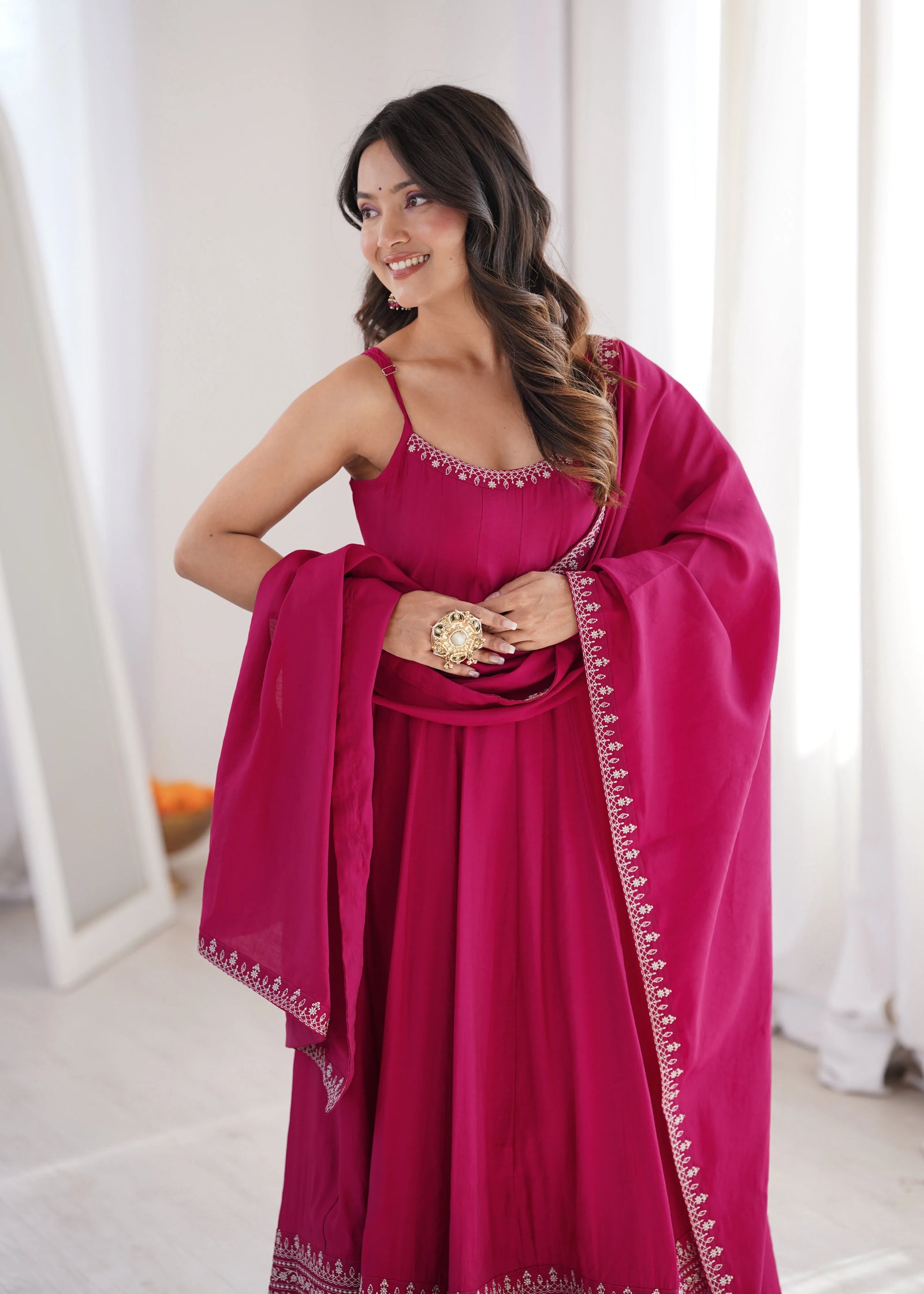 Woman wearing a pink traditional outfit with a white background