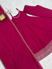 Maroon traditional outfit with intricate border on a white background