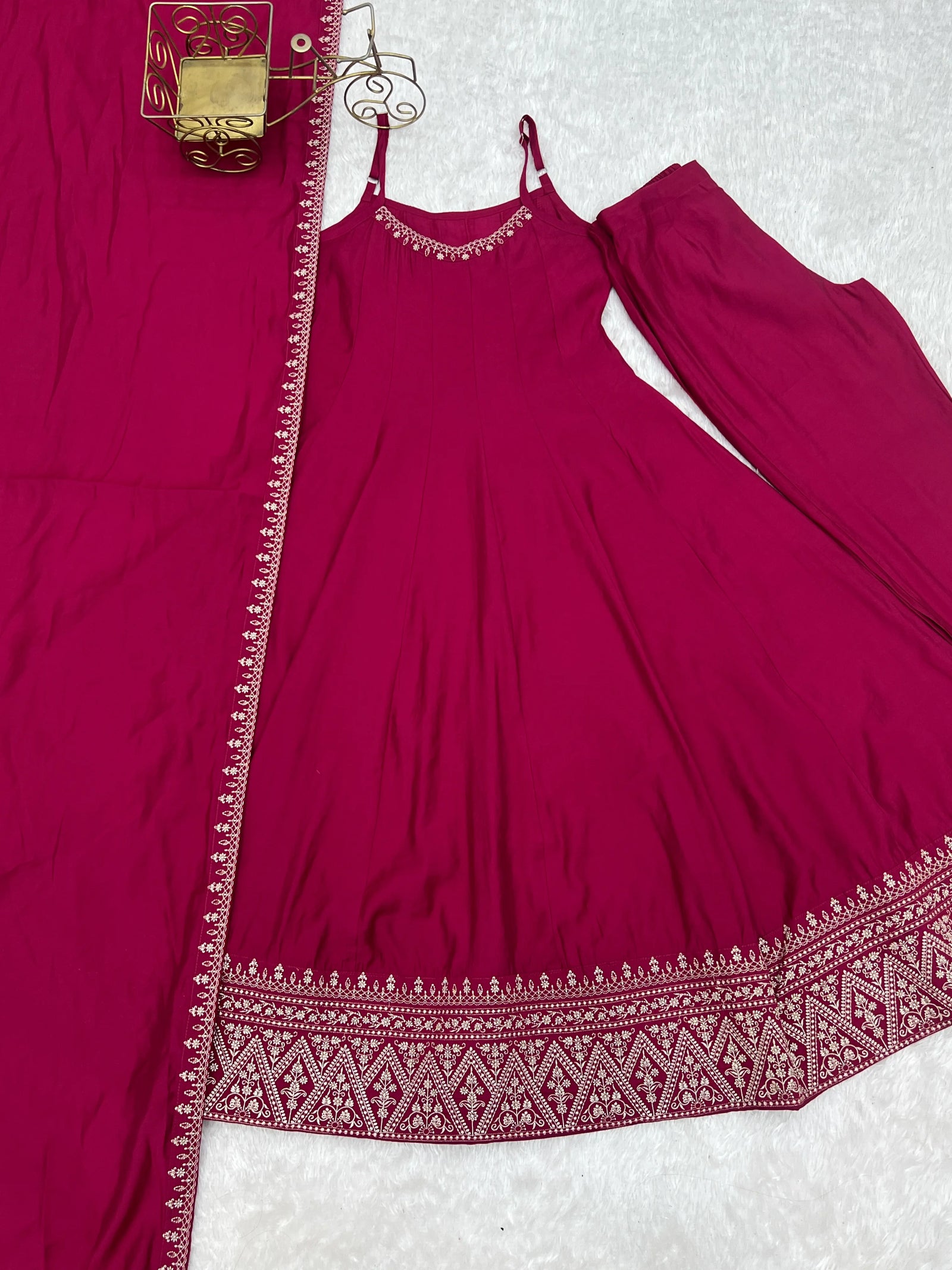 Red dress with white embroidery on a textured surface