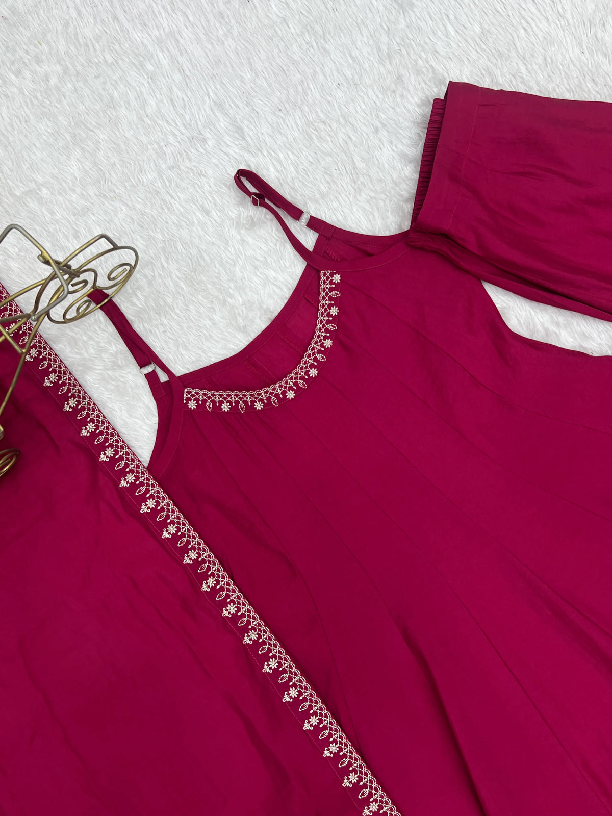 Maroon dress with lace details on a white background