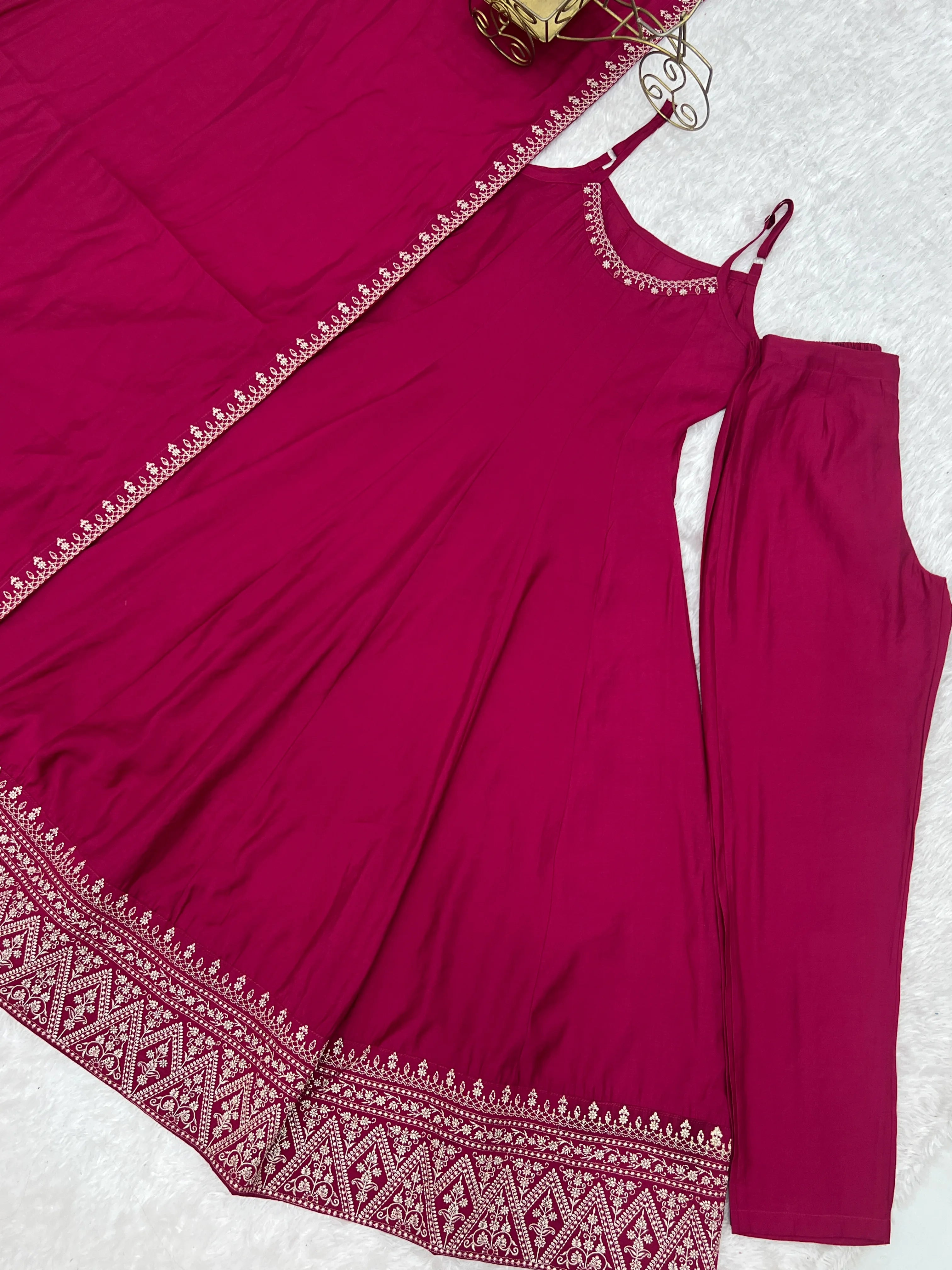 Maroon outfit with embroidered details on a white background