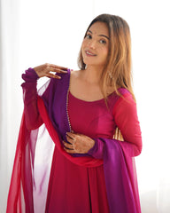 Woman wearing a pink and purple traditional outfit with a white background