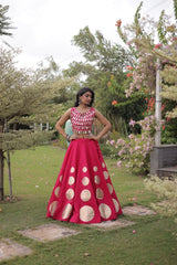 Eye-catching golden circular foil patterns add a bold and fashionable touch to the flowing pink skirt.