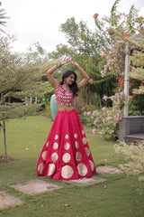 Stylish ethnic outfit combining a contemporary mirror work blouse with a graceful full-flare designer skirt.