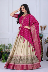 Woman wearing a traditional outfit with a pink dupatta and beige lehenga against a white background.