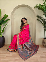 Woman in a pink saree standing in a room with plants