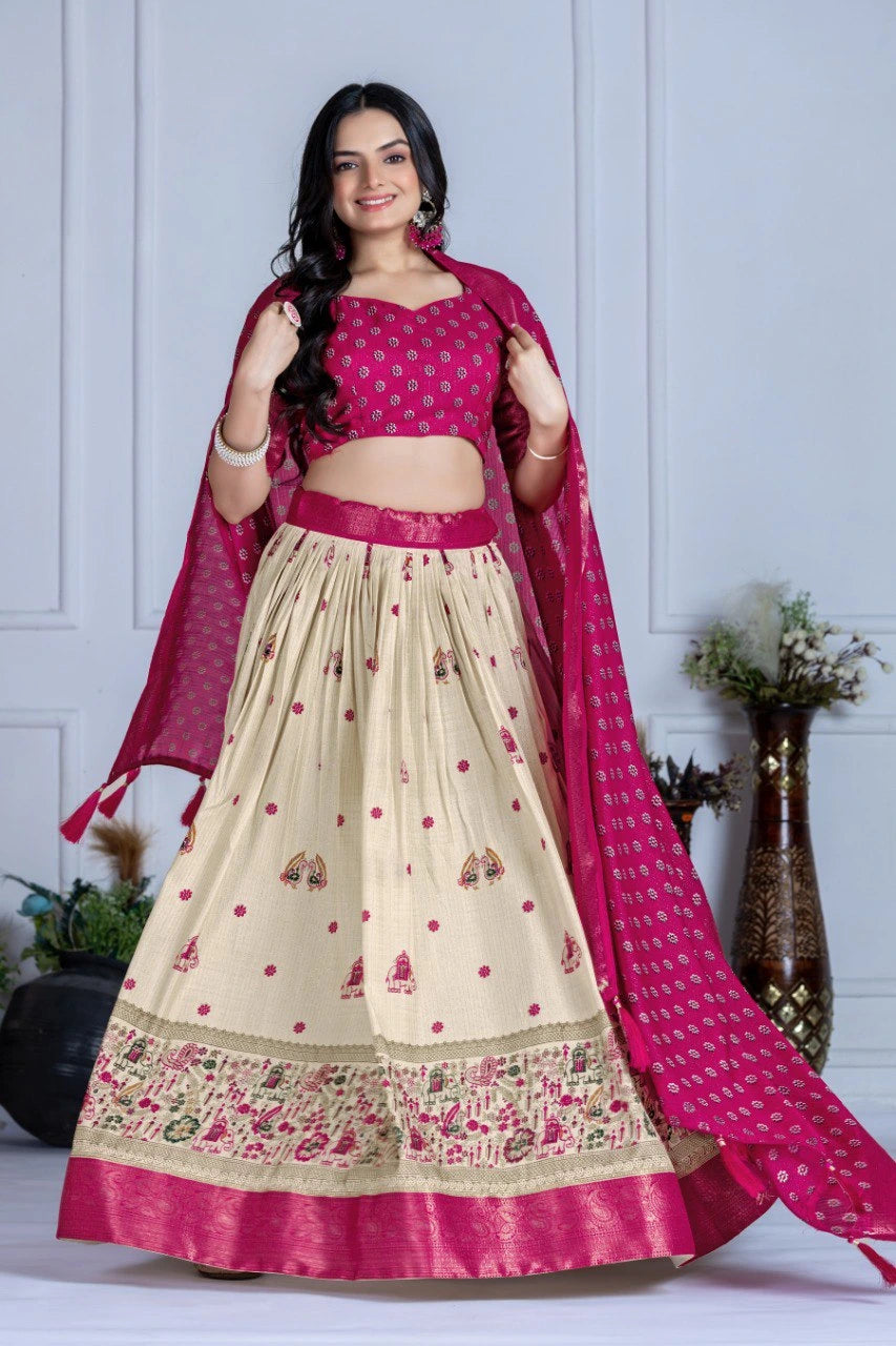 Woman wearing a traditional outfit with a pink and beige lehenga against a white background