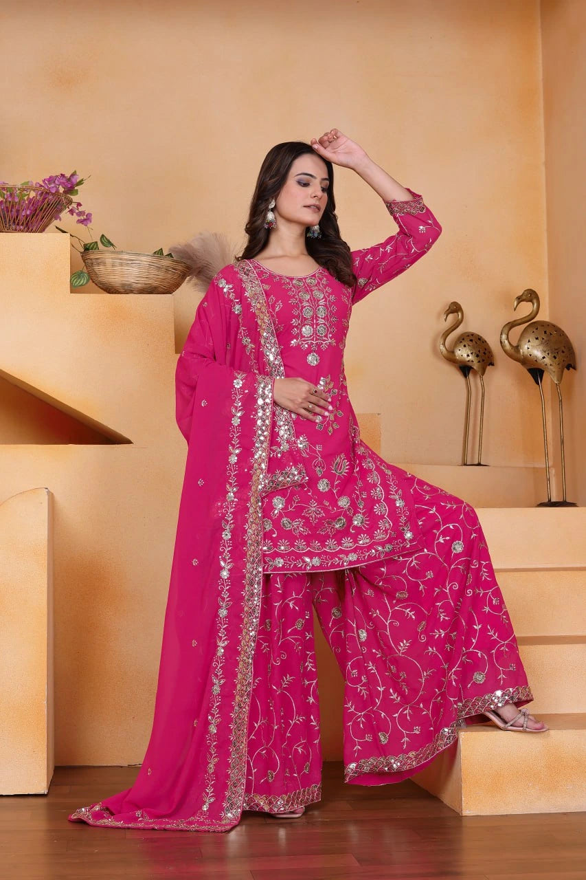 Woman in a pink traditional outfit with silver embroidery on a beige background