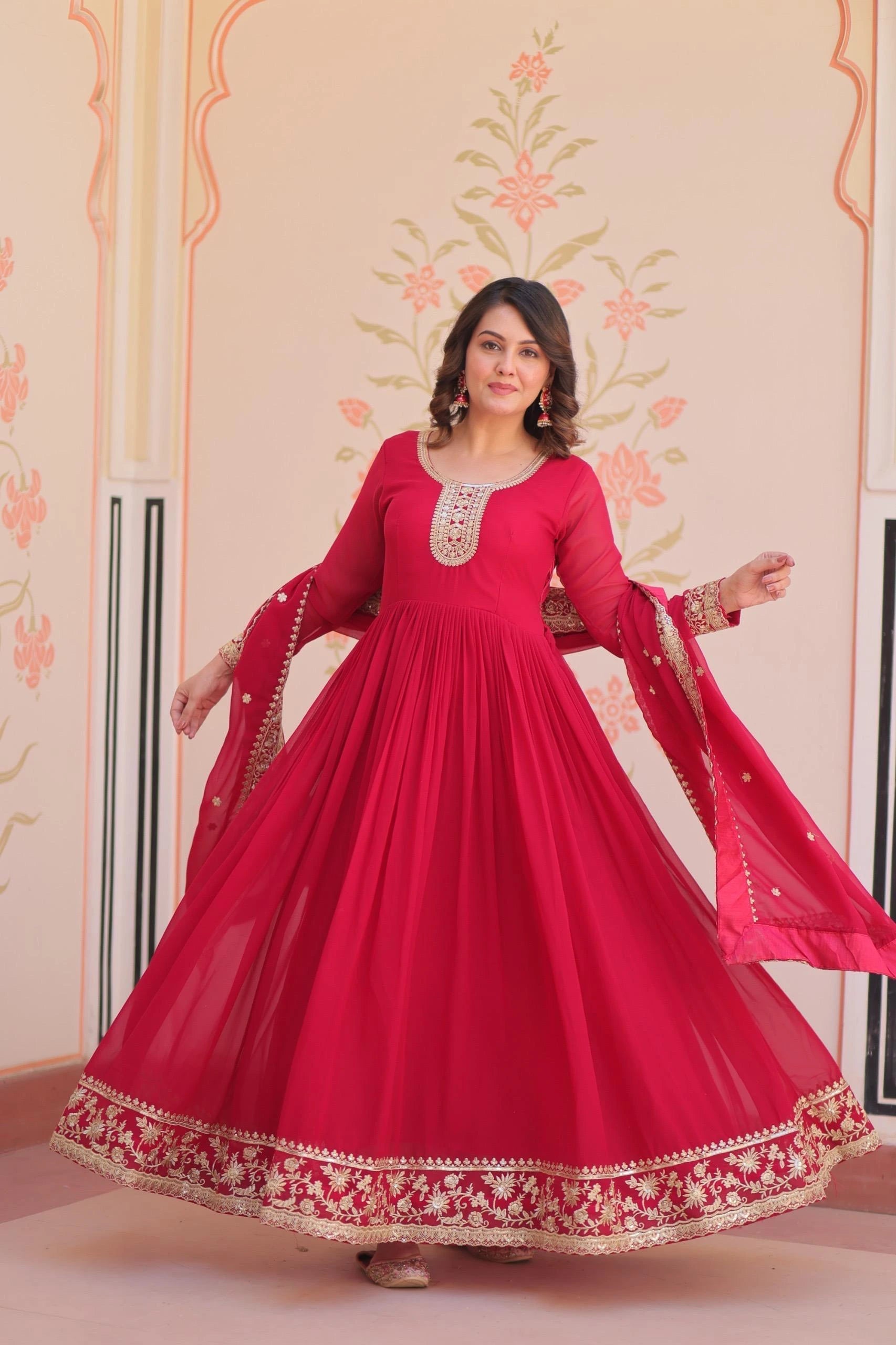 Woman wearing a red traditional outfit with floral patterns in the background