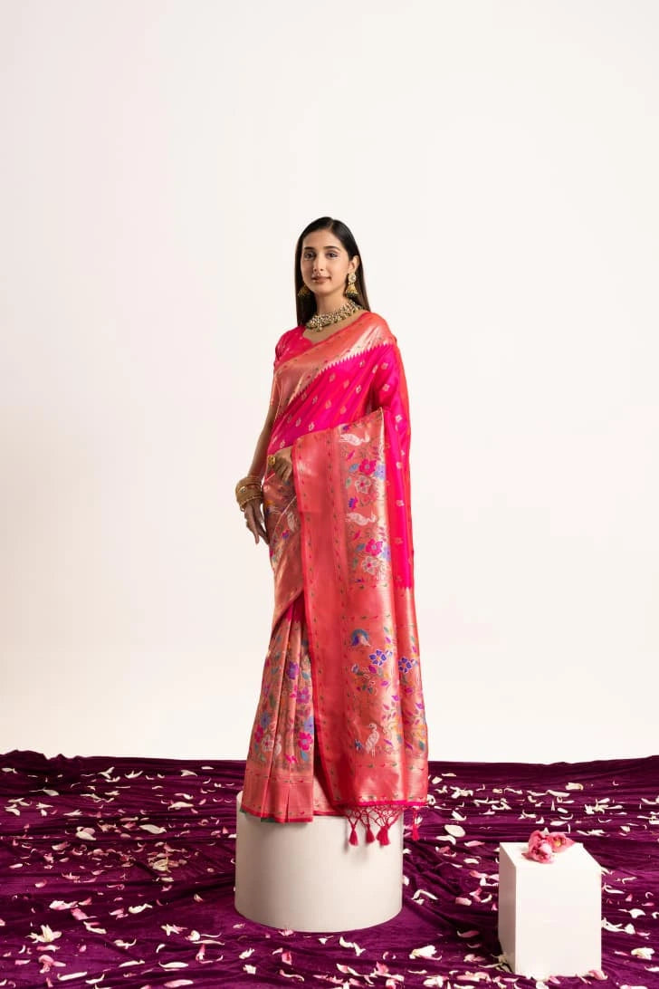 Woman wearing a pink saree with a white background