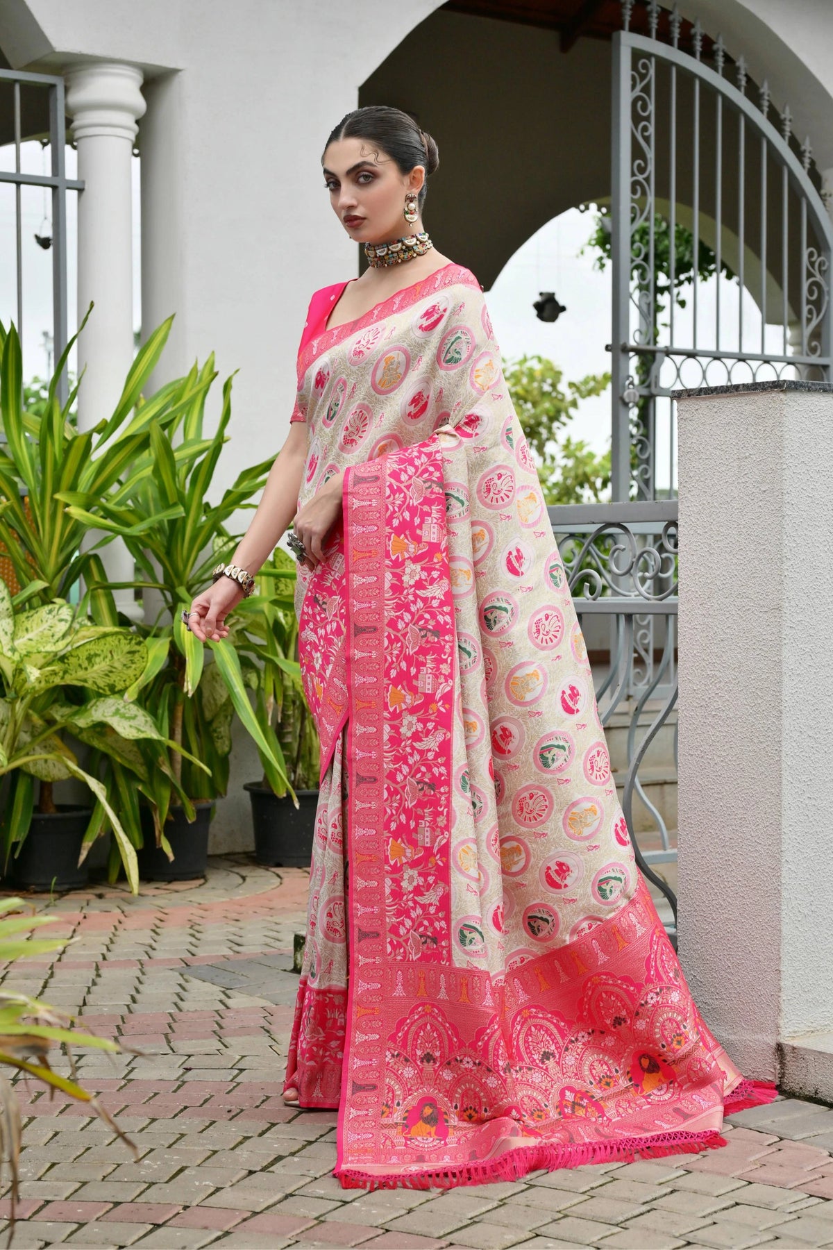 "Dark pink Banarasi silk saree with golden zari weaving displayed on mannequin.