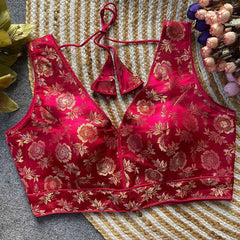 Red floral-patterned bra and panties set on a textured surface.