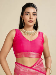 Woman wearing a pink traditional outfit with jewelry on a beige background