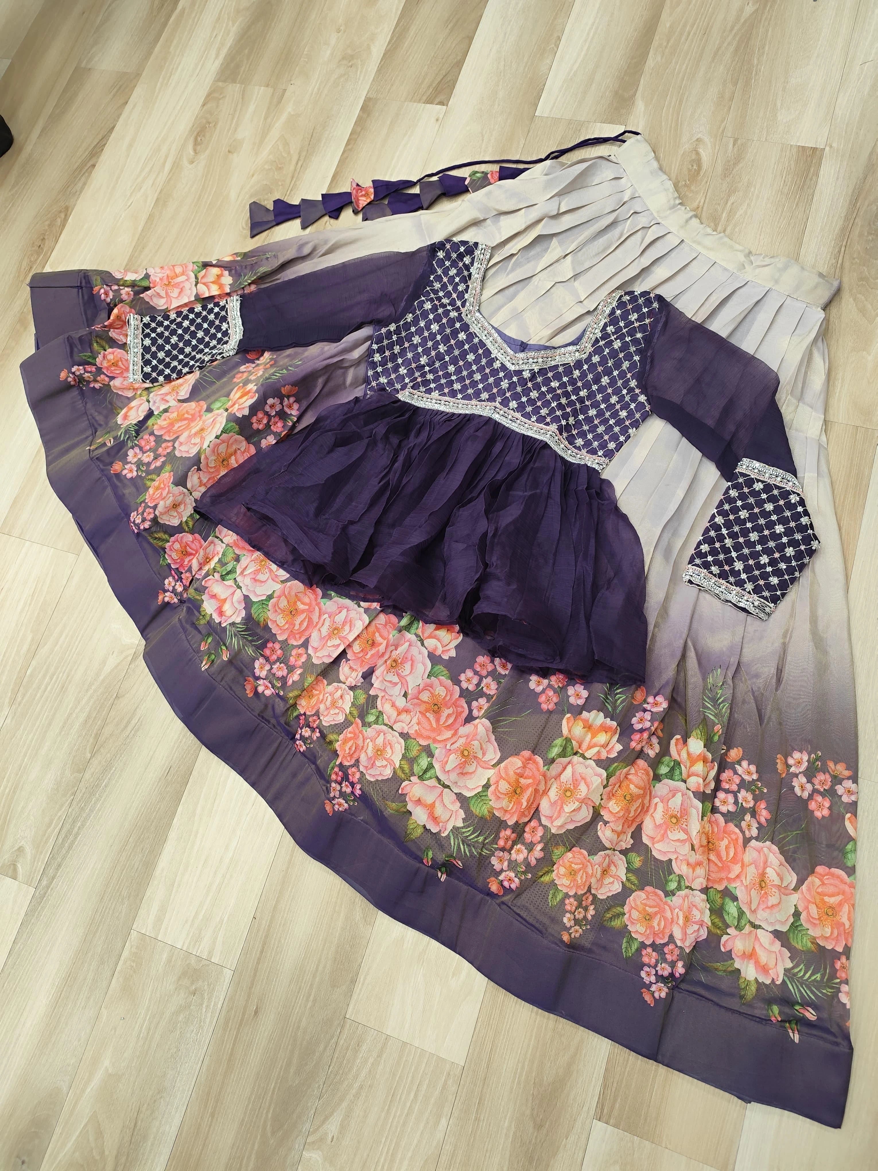 Purple dress with floral skirt and checkered sleeves on a wooden floor