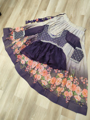 Purple dress with floral skirt and checkered sleeves on a wooden floor