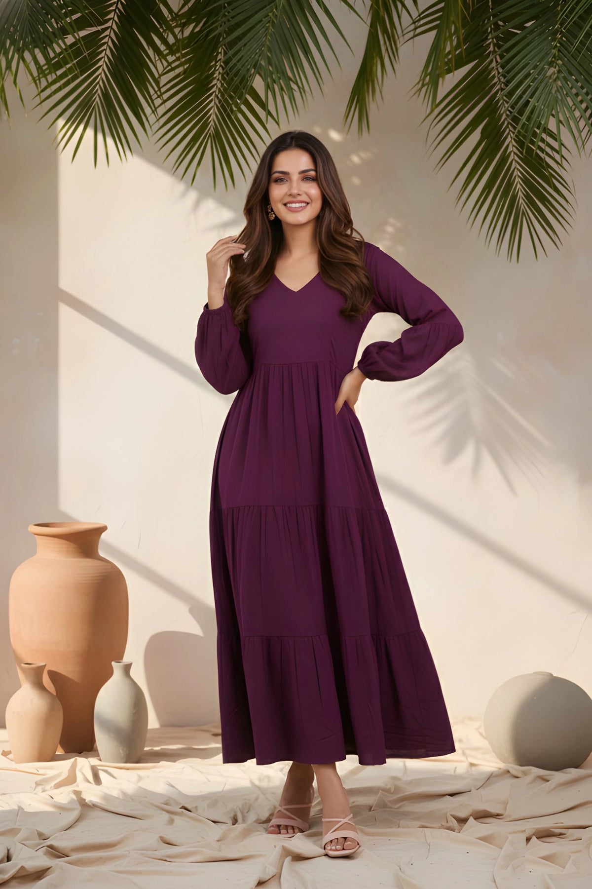 Woman wearing a purple dress standing in a decorative setting with vases and plants.