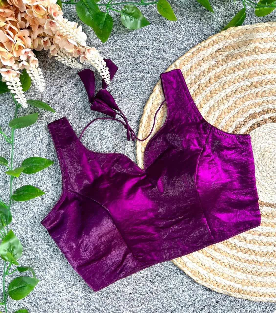Purple velvet top on a textured surface with decorative elements