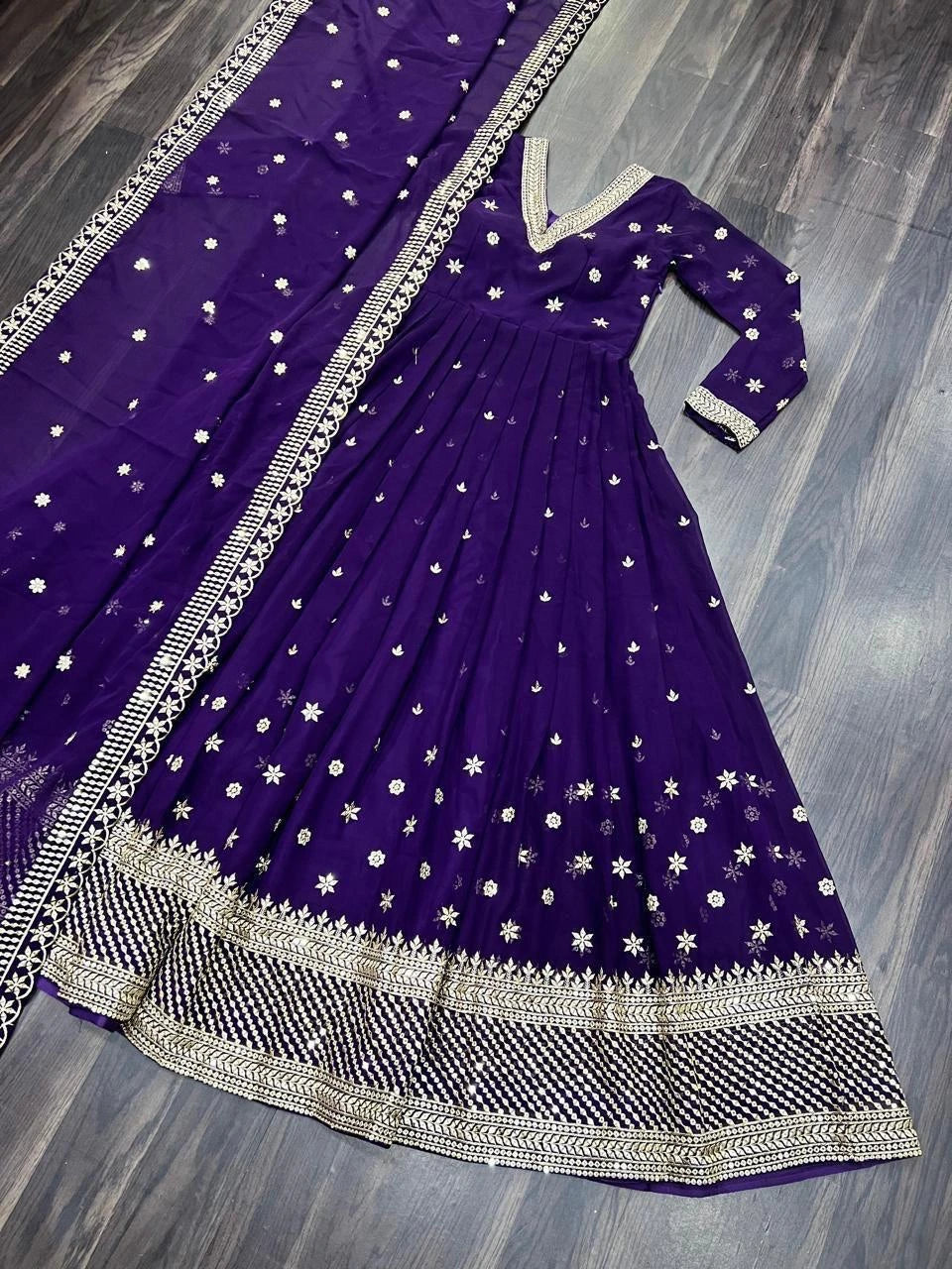 Purple traditional outfit with white floral patterns on a wooden floor