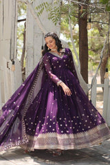 Woman in a purple traditional outfit with star patterns standing outdoors.