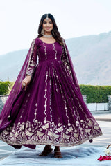 Woman in a purple embroidered dress with a matching dupatta outdoors.