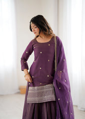 Woman wearing a purple traditional outfit with a white background