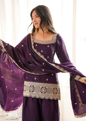 Woman wearing a purple traditional outfit with gold embroidery in a bright setting