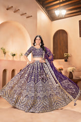Woman in a traditional purple and gold embroidered outfit in an elegant indoor setting.