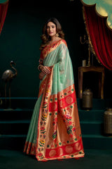 Woman wearing a traditional saree with a dark background