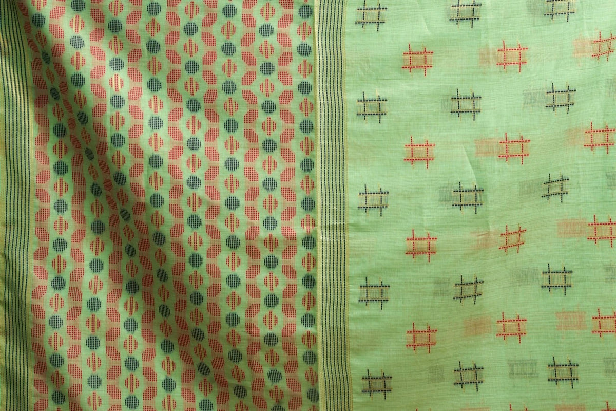 Fabric with a green background and red and black pattern