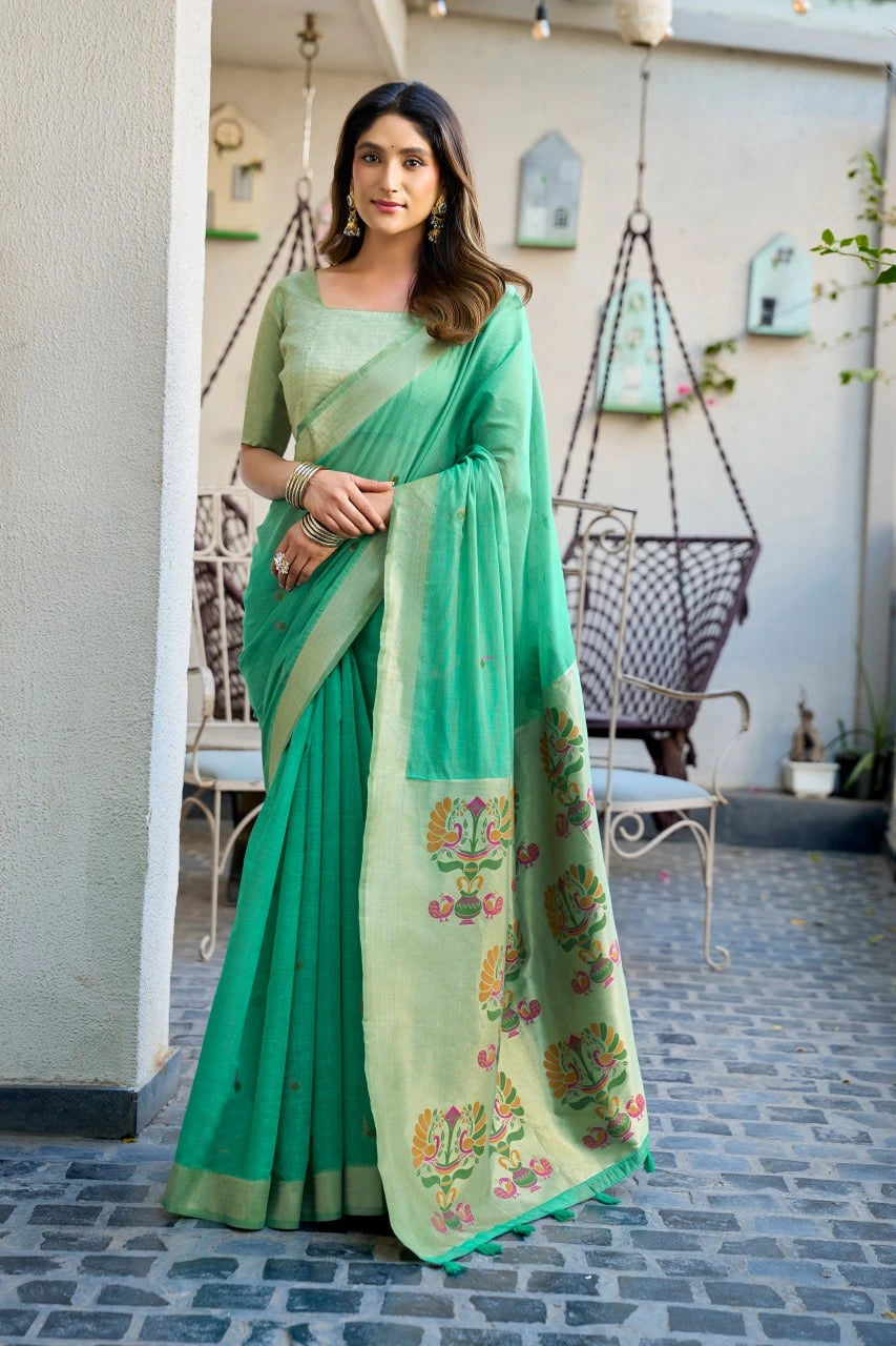 Woman wearing a green saree with floral patterns in an outdoor setting