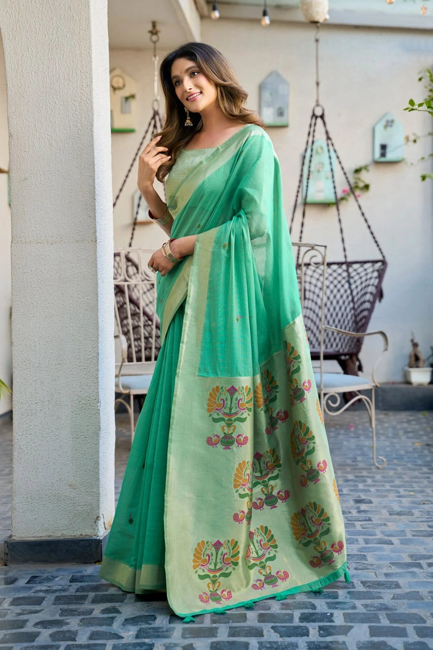 Woman wearing a light green saree with floral patterns in an outdoor setting