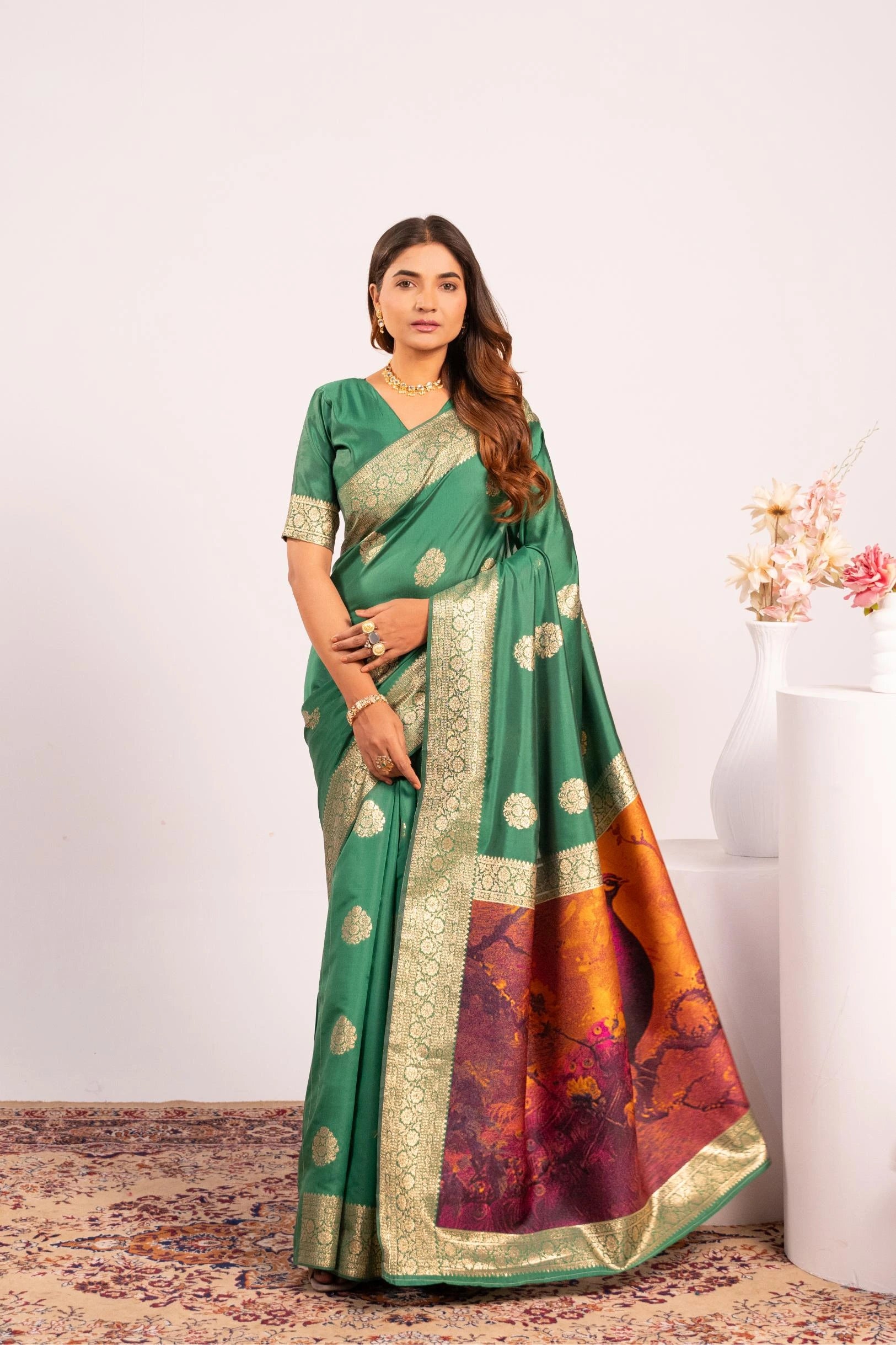 Woman wearing a green saree with a white background