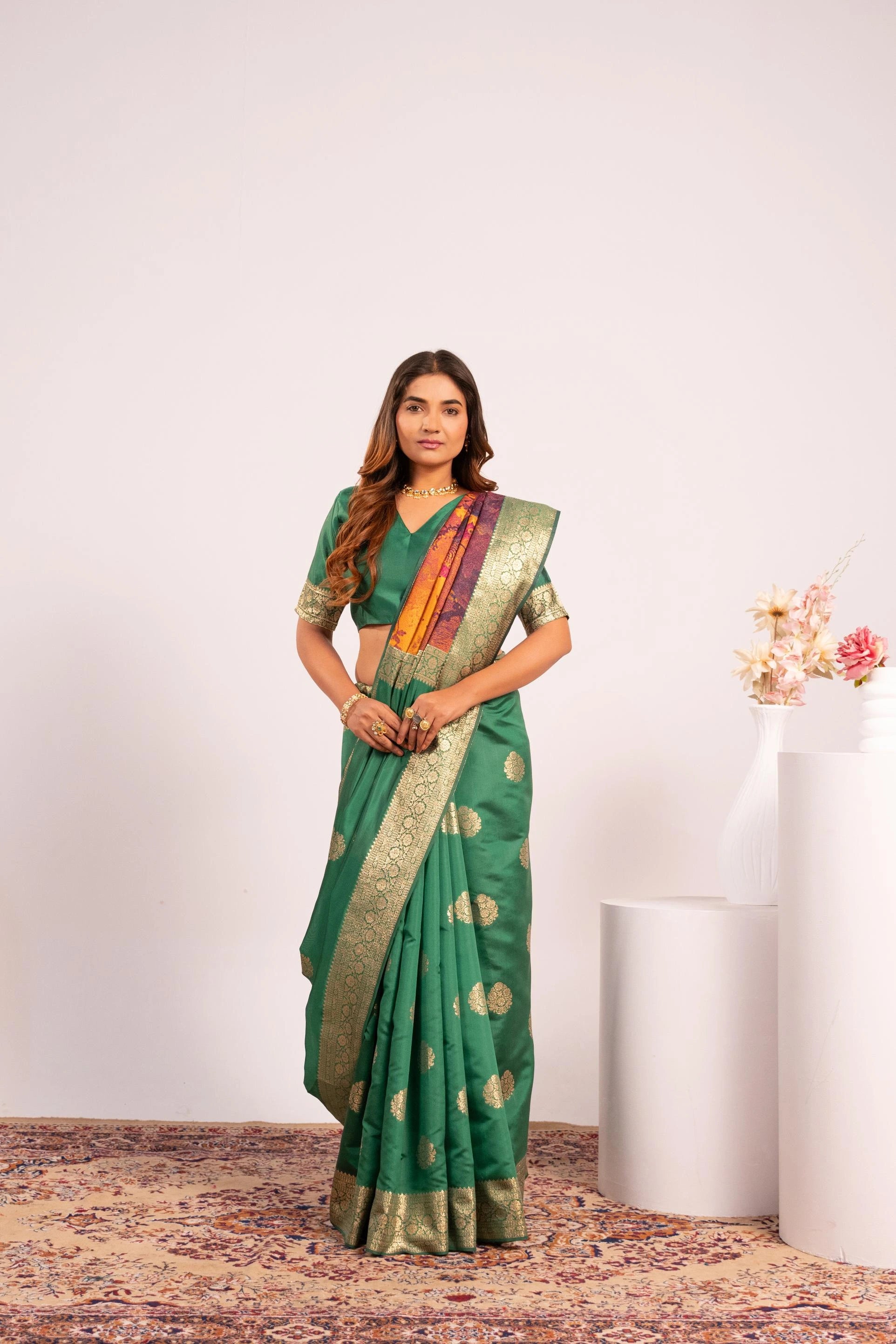 Woman wearing a green saree with a white background