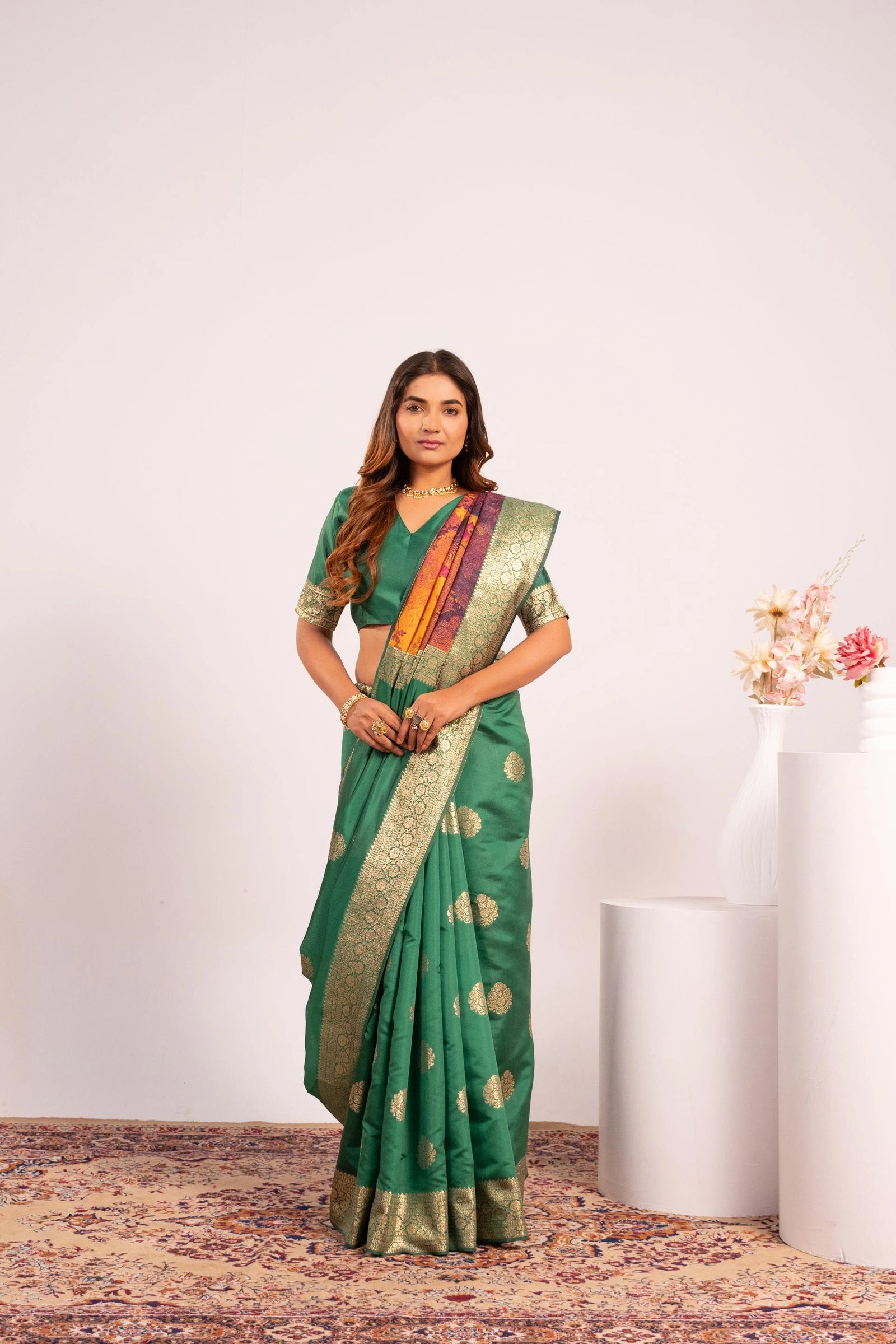 Woman wearing a green saree with a white background