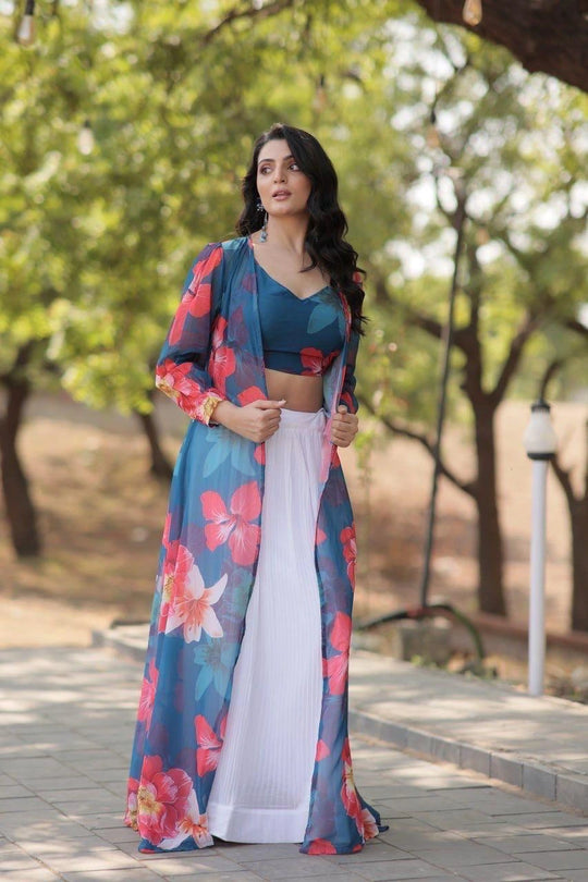 Woman in a floral outfit standing outdoors with trees in the background