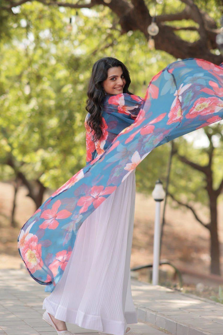 Woman in a floral saree with a blurred natural background