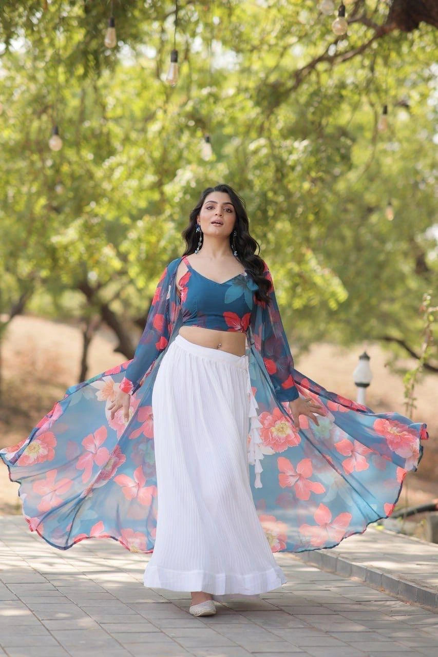 Woman in a floral outfit standing outdoors with trees in the background