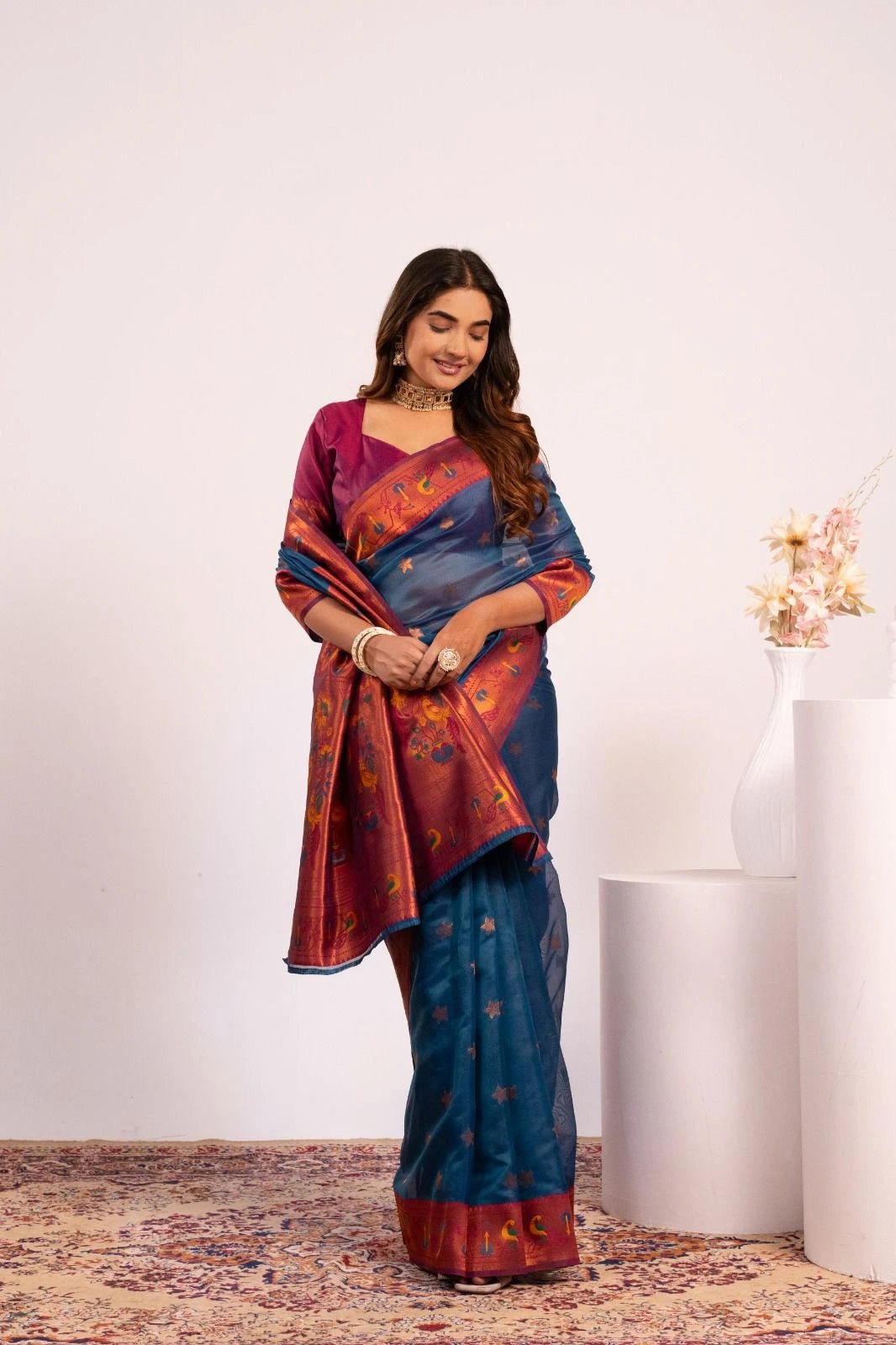 Woman wearing a colorful saree with a white background