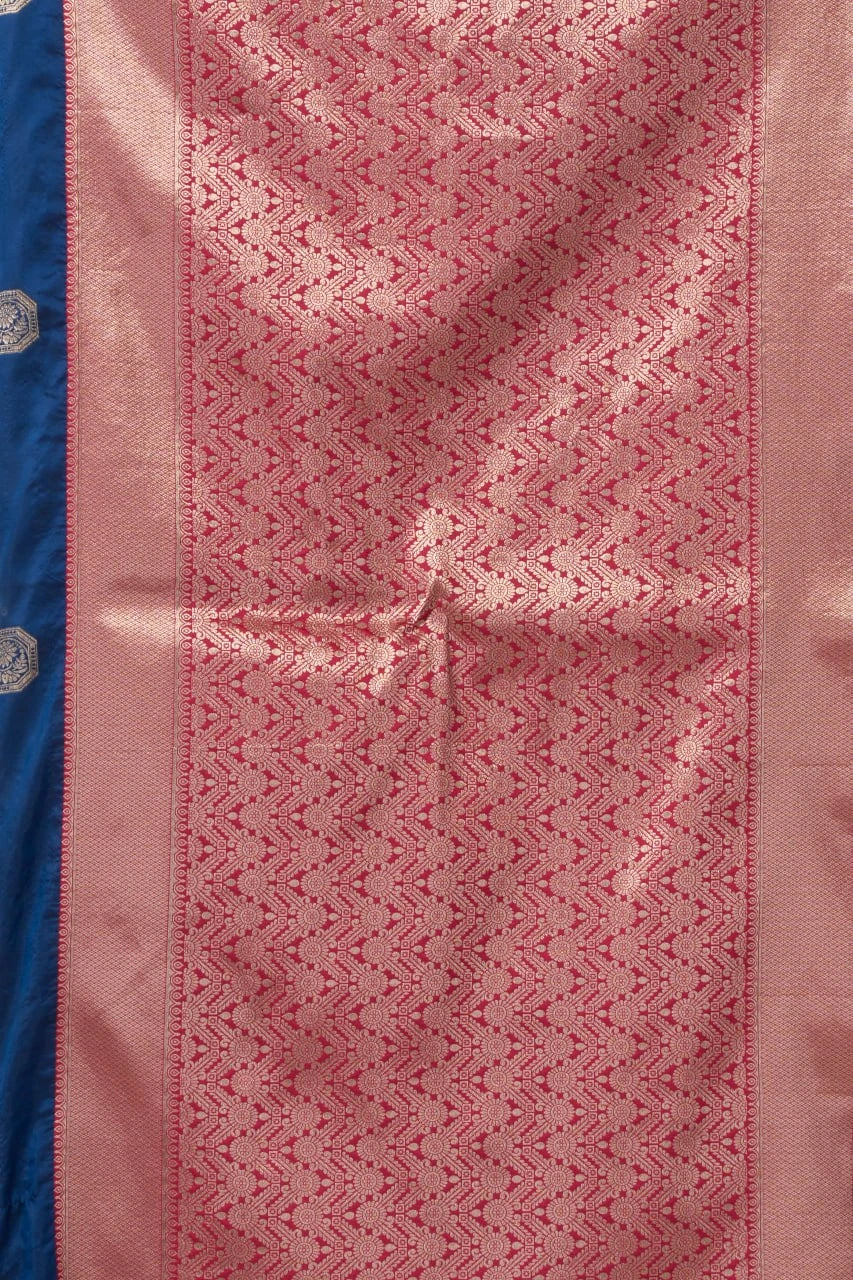 Close-up of a pink fabric with intricate patterns on a blue background