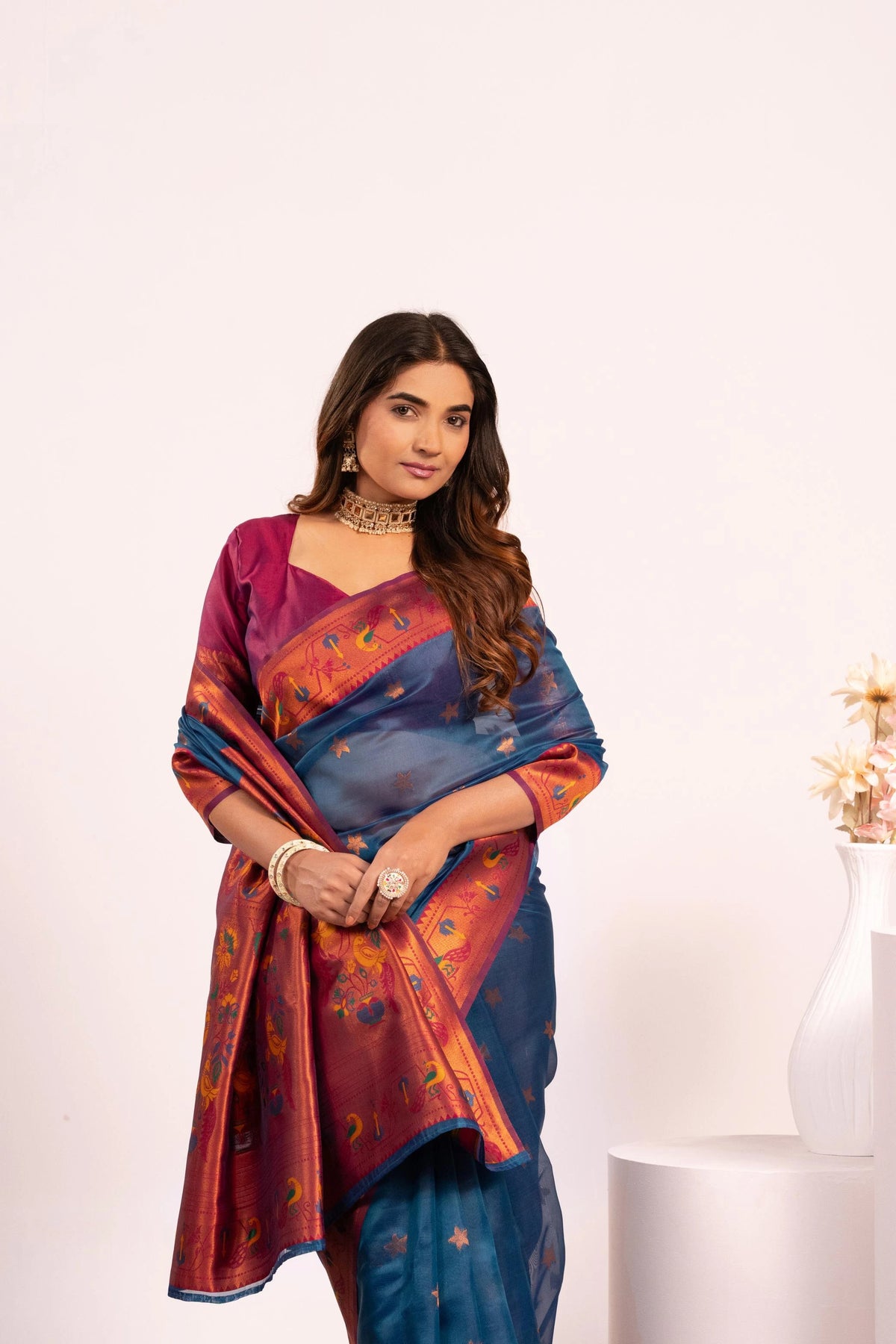 Woman wearing a colorful saree with a white background