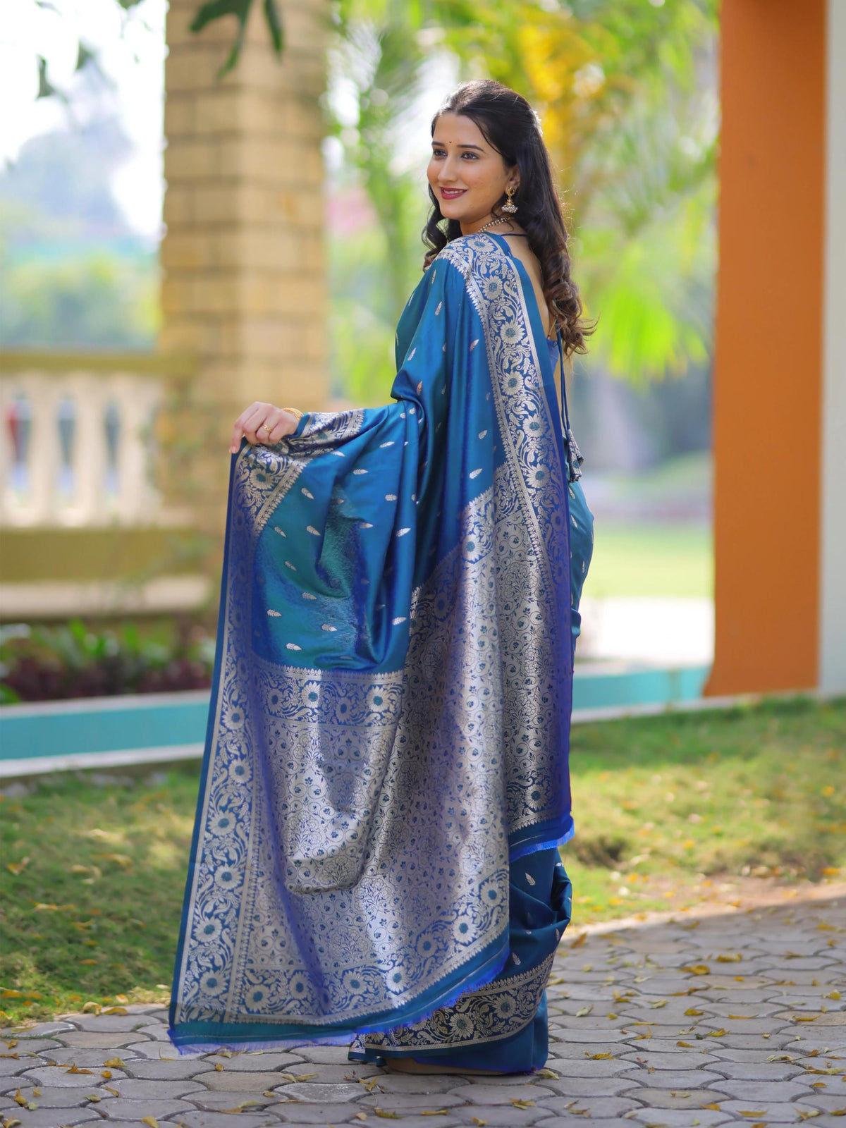 Woman wearing a blue and silver saree outdoors