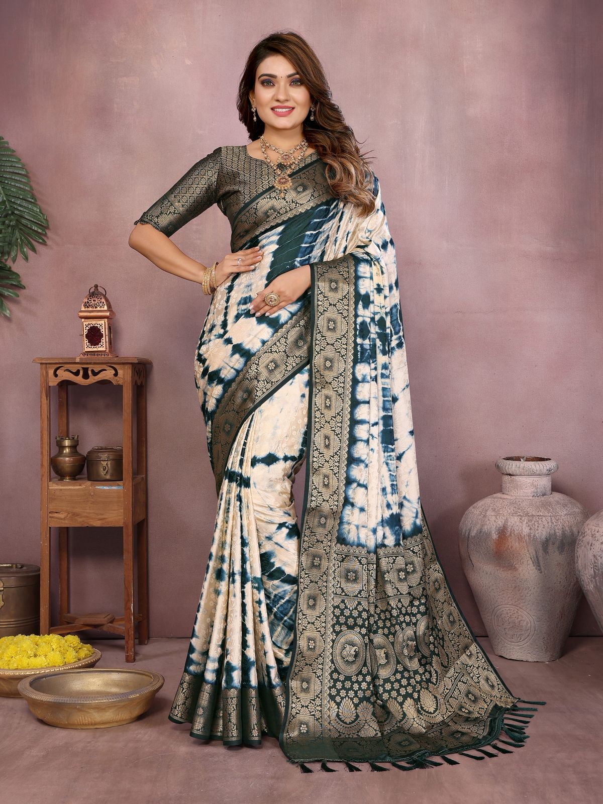 Woman wearing a traditional saree with a patterned design against a neutral background