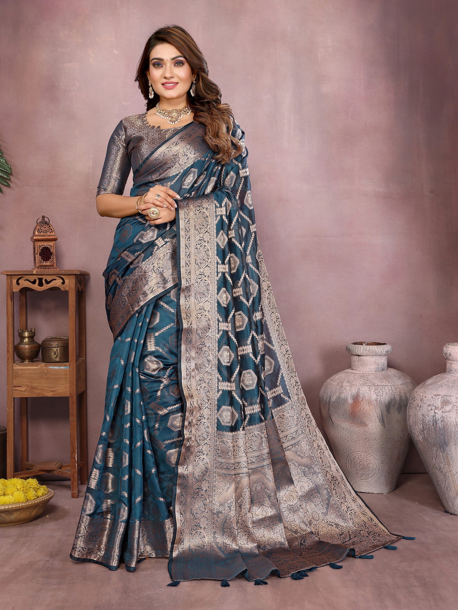 Woman wearing a blue and silver saree with a blurred background