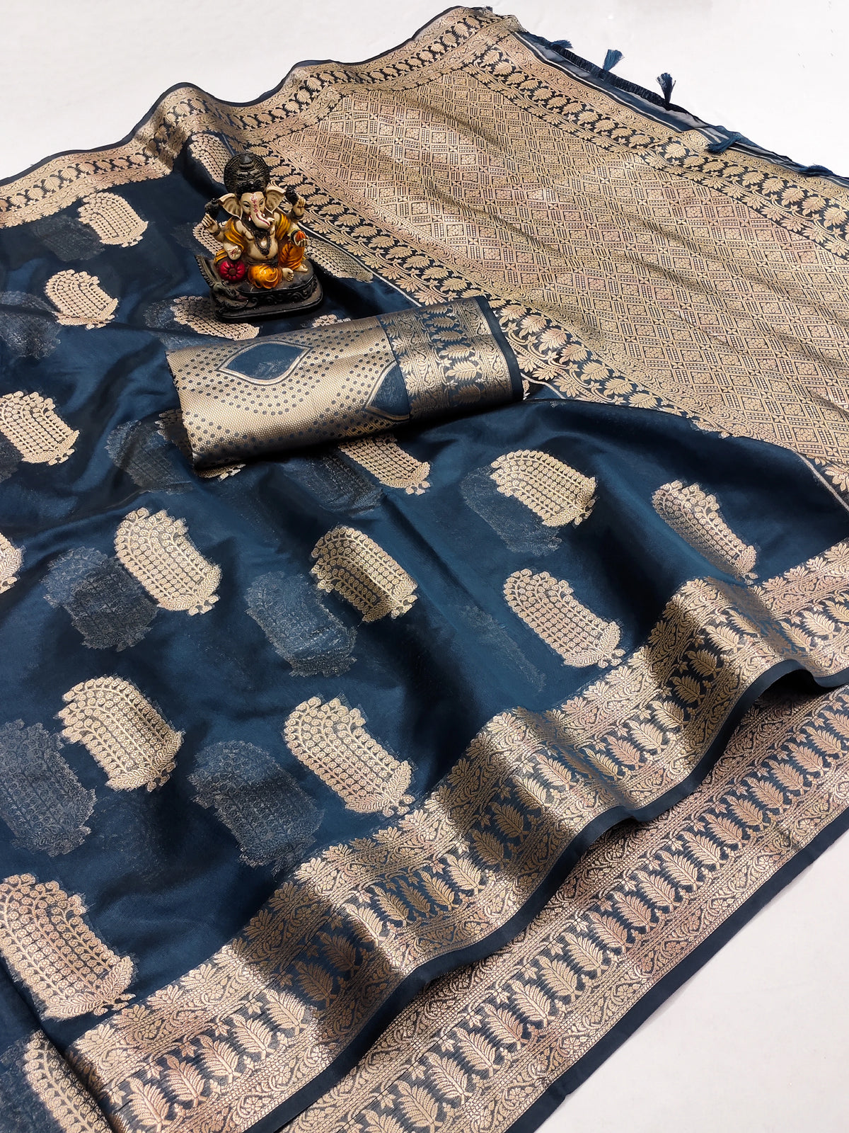 Blue and beige saree with intricate patterns on a white background