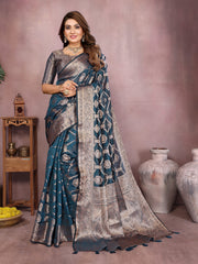 Woman wearing a blue and silver saree with a blurred background