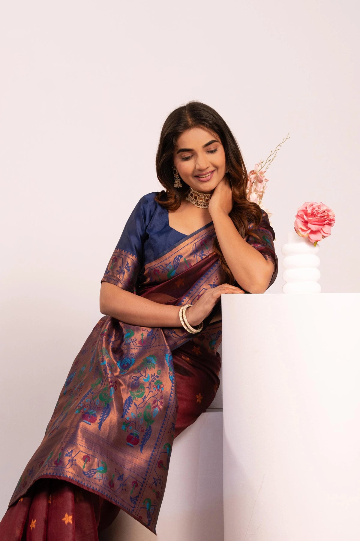 Woman wearing a traditional saree with a white background